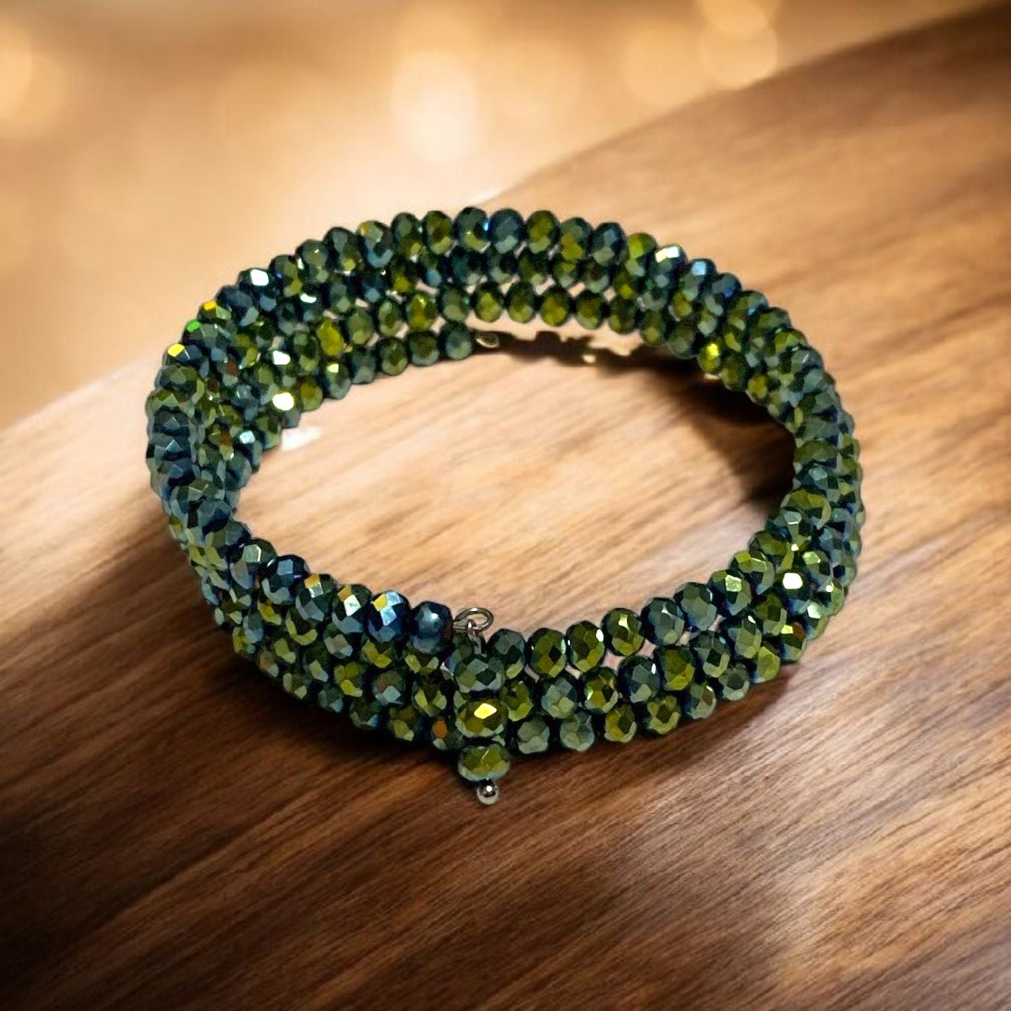 Navy and Green Crystal Memory Wrap Bracelet, displayed on wooden table. Photo and Bracelet by Divalicious Designs.