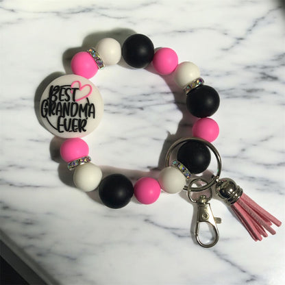 Beaded keychain with 'Best Grandma Ever' charm on a marble background