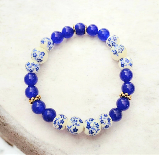 A dark blue chalcedony and delft blue ceramic beaded bravelet with minimalist silver accents. Photo and bracelet by Divalicious Designs.