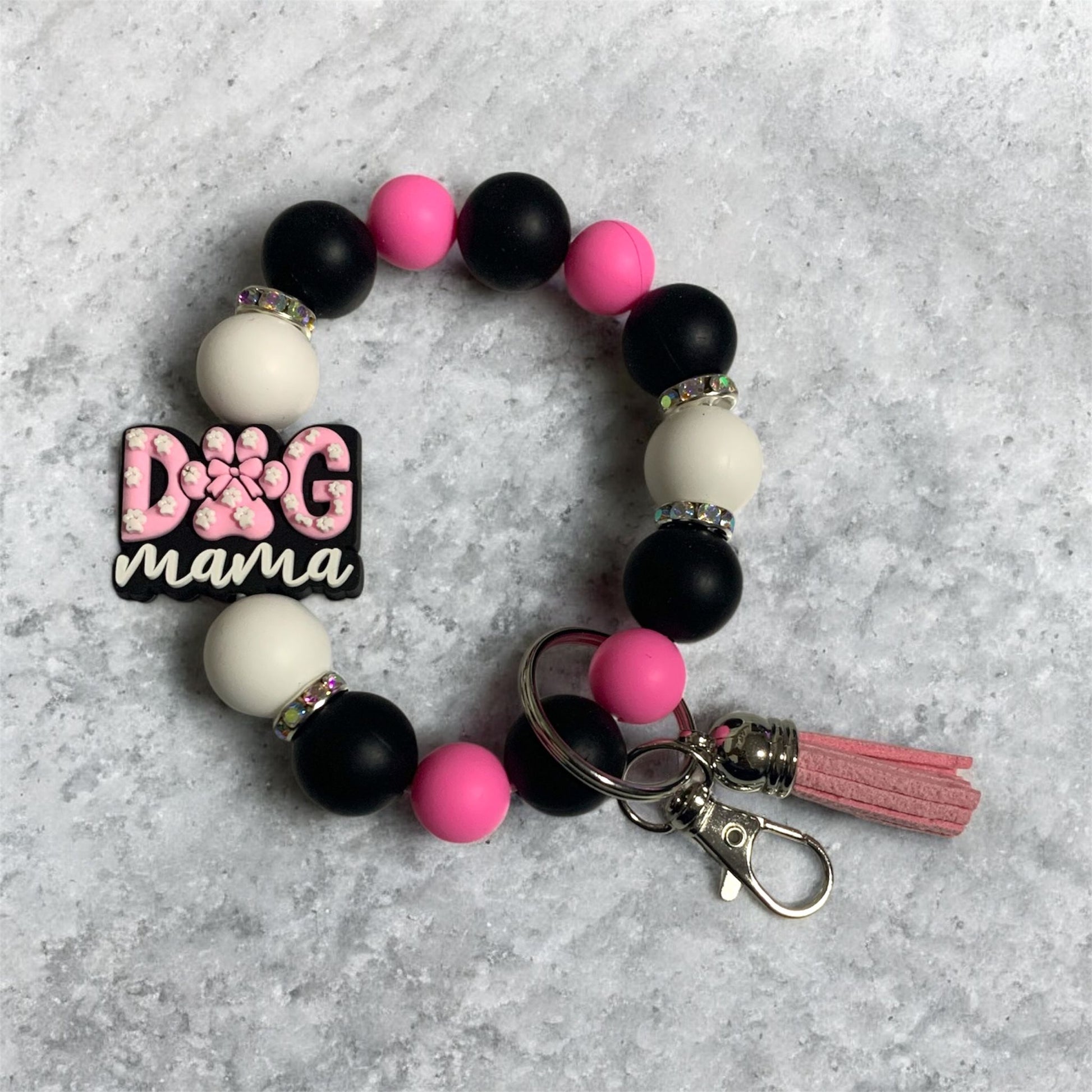 Colorful silicone beaded keychain wristlet with 'Dog Mama' focal bead on a gray background