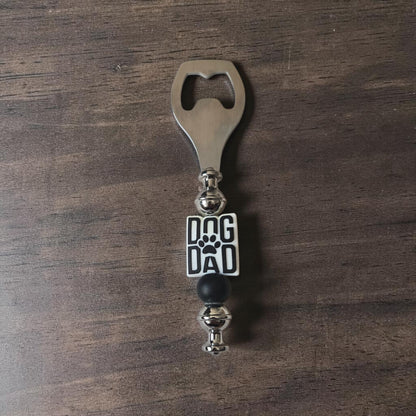 Steel and Silicone Bottle opener with 'Dog Dad' focal bead on a wooden surface.  Made by Divalicious Designs in Mississauga 