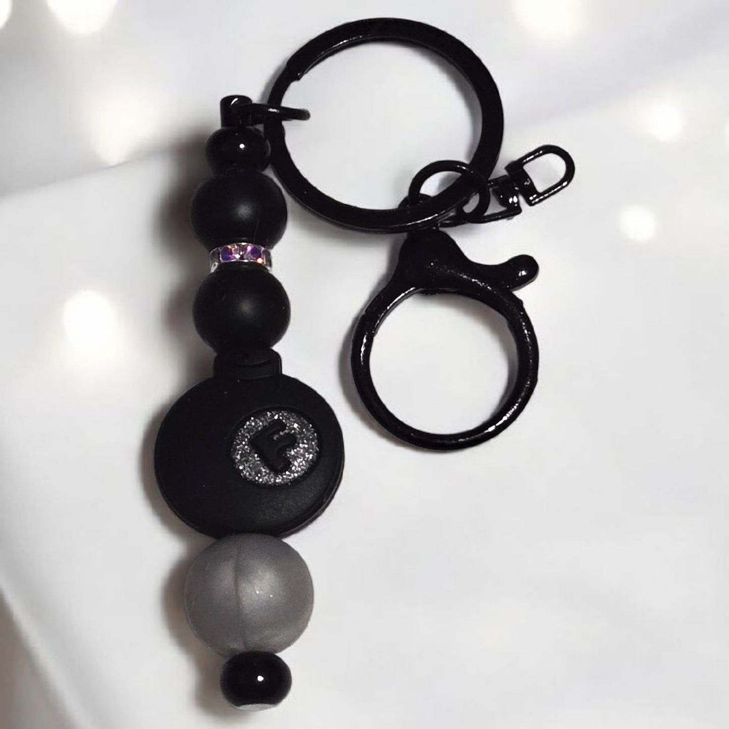 Black keychain with silicone beads and a black F-Bomb focal bead displayed on a white background.