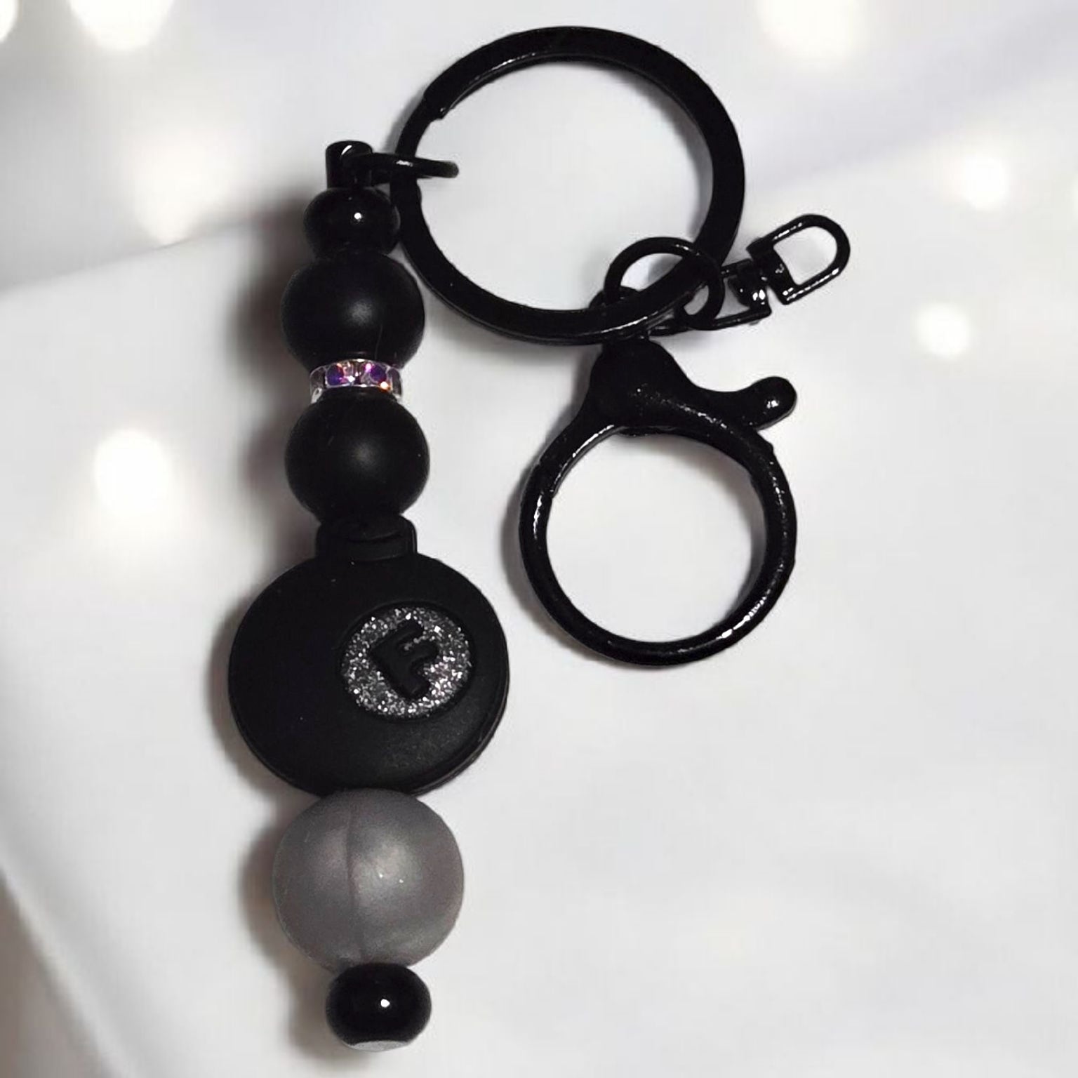 Black keychain with silicone beads and a black F-Bomb focal bead displayed on a white background.