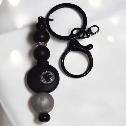 Black keychain with silicone beads and a black F-Bomb focal bead displayed on a white background.