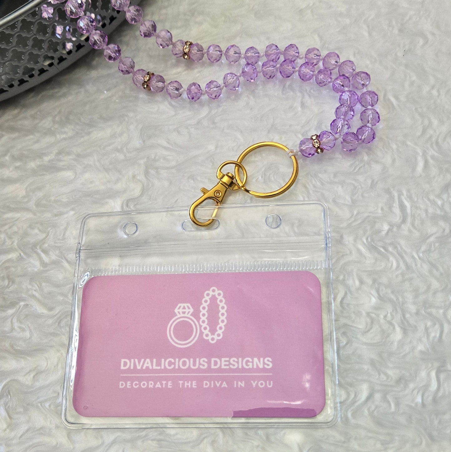 Lilac crystal ID Lanyard with 'Divalicious Designs' branding on a textured surface