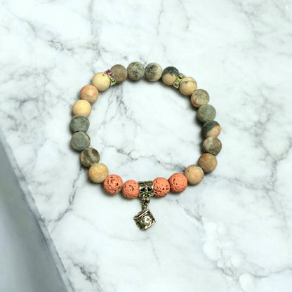 Matte pink Zebra Jasper Bracelet on a light marble surface