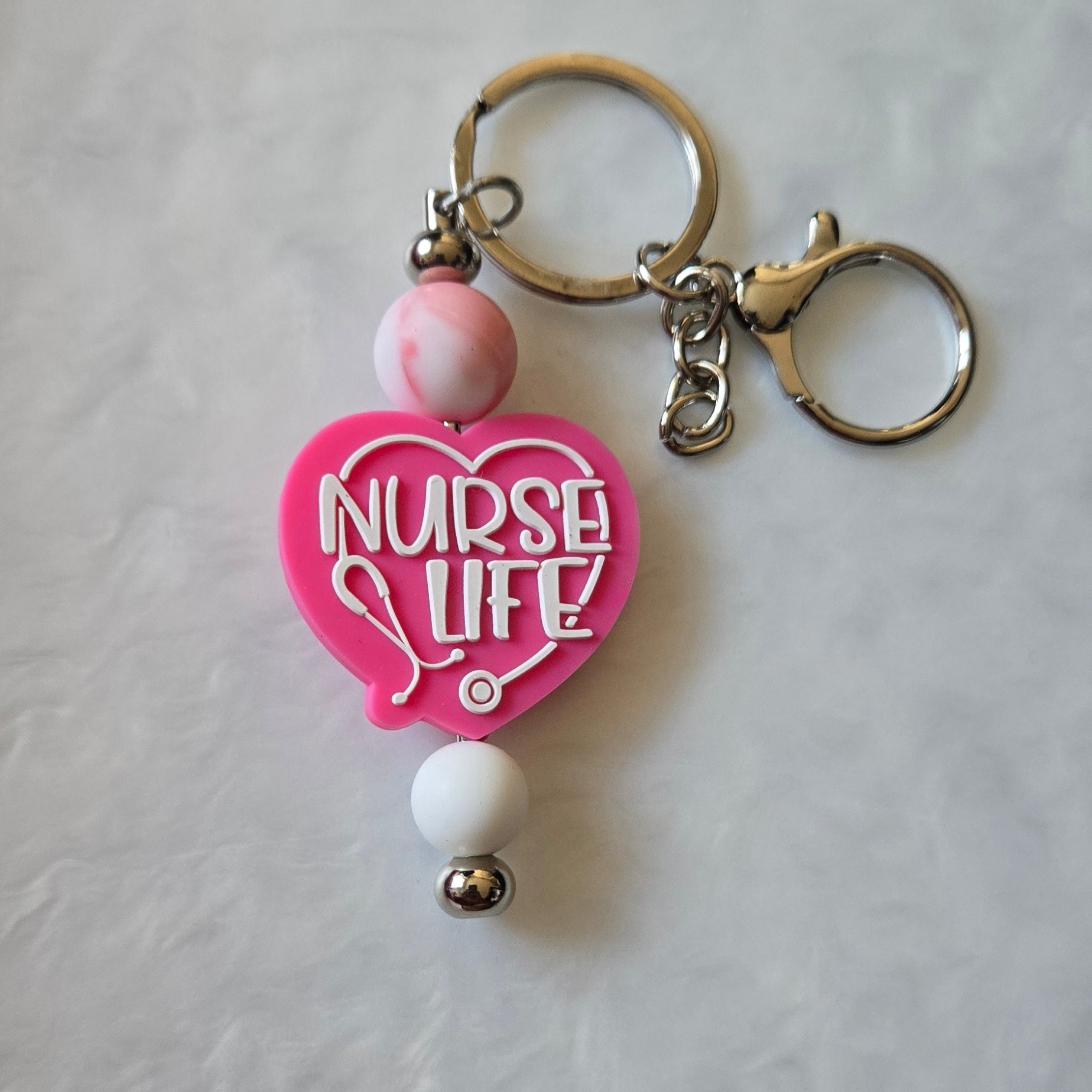 Keychain with 'Nurse Life' heart-shaped tag on a light gray background