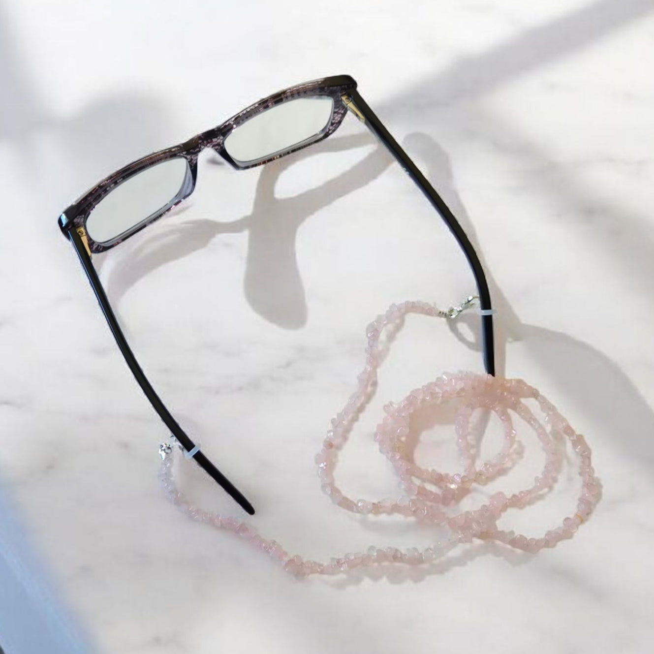 Rose Quartz Stone Chip Glasses or Mask Lanyard on a light surface.