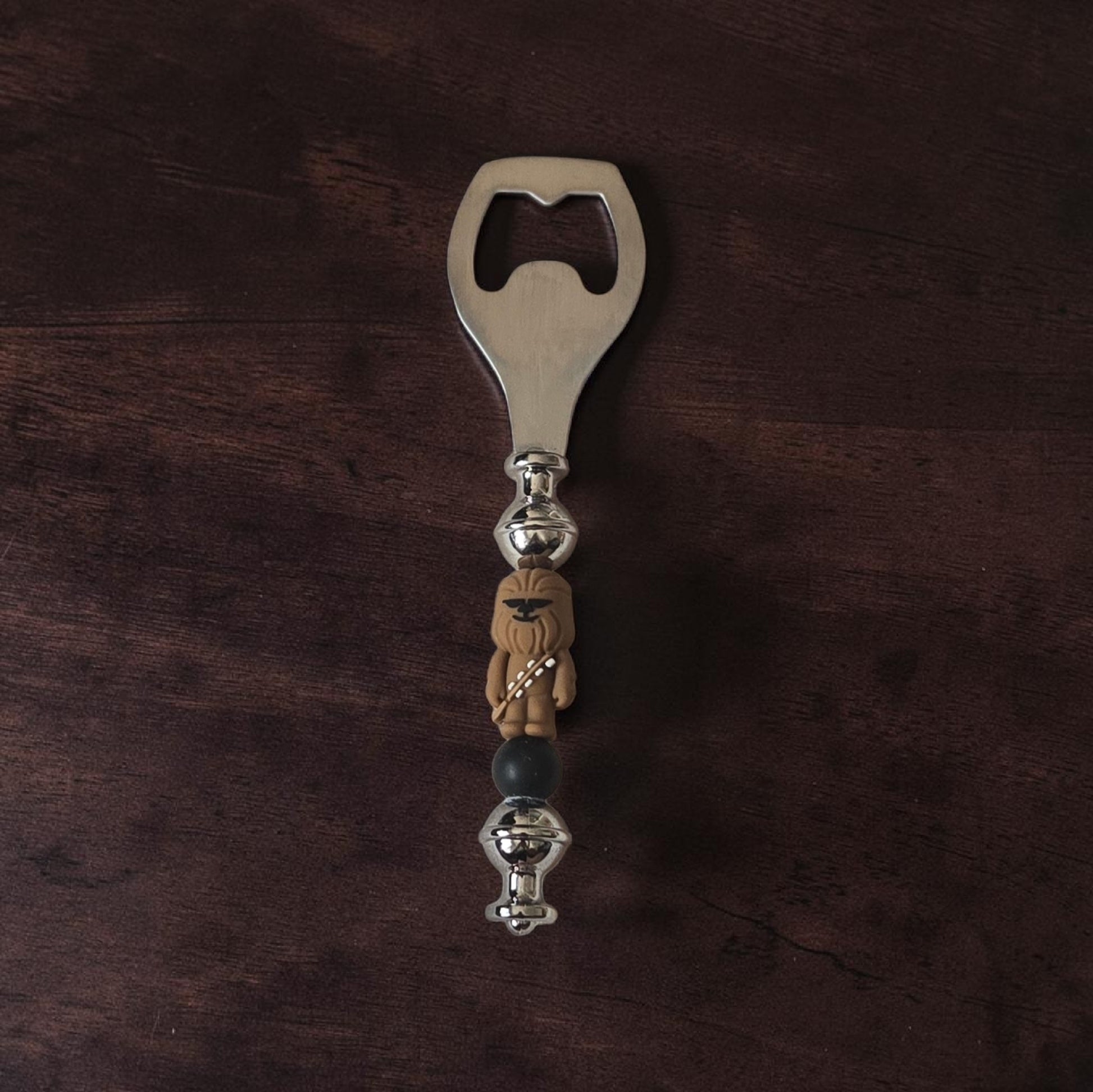 Star Wars themed Beer Bottle opener with chewbacca design on a dark wooden surface