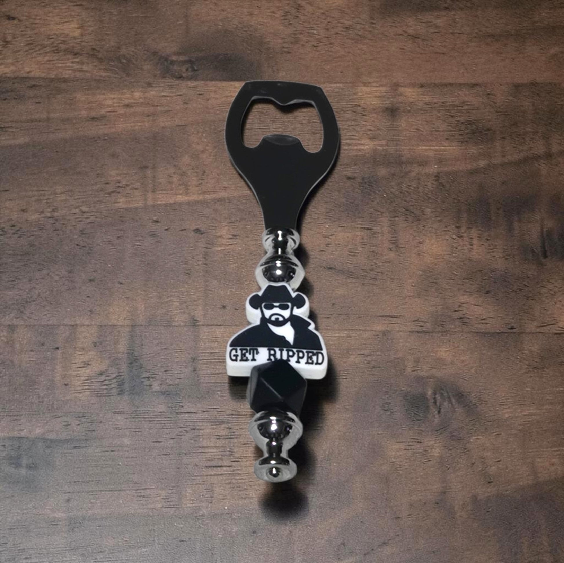 Yellowstone, Dutton Ranch Beer Bottle opener with a character Rip Wheeler and 'GET RIPPED' text on a wooden surface
