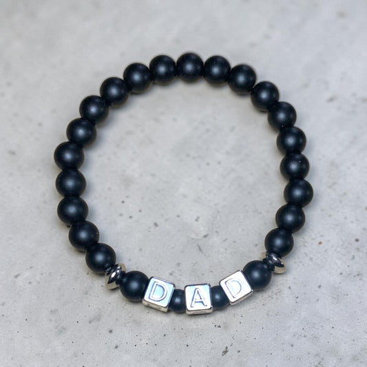 Handmade matte onyx dad bracelet with stainless steel DAD letter beads and silver accent spacers for Father’s Day gift.